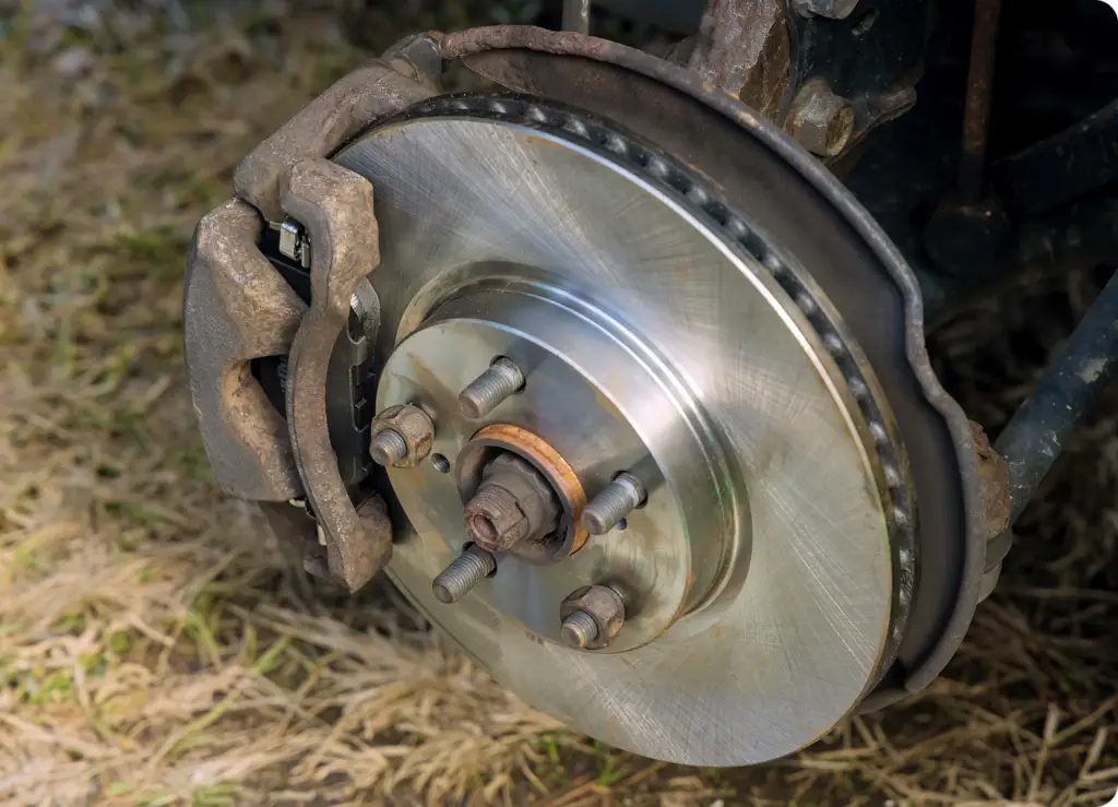 7 Essential Car Services You Can Book From Your Phone Image of a brake rotor being service - on-demand car service by Revilo Auto Care from revilo autocare