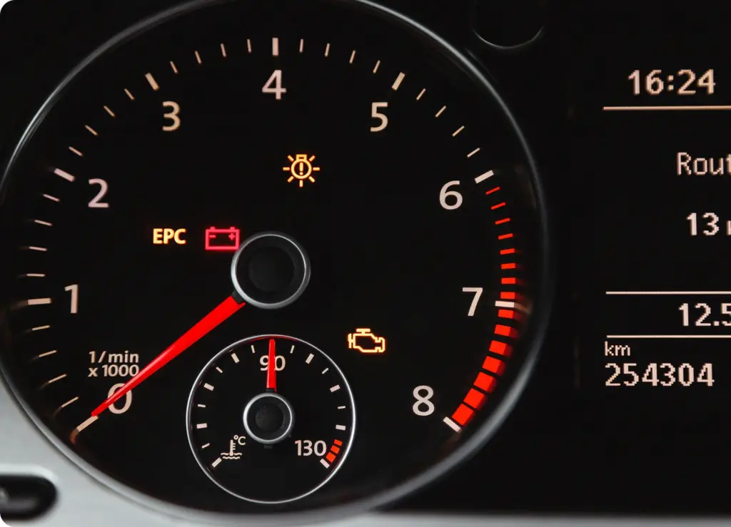 7 Essential Car Services You Can Book From Your Phone An image of a speedometer showing a check engine light