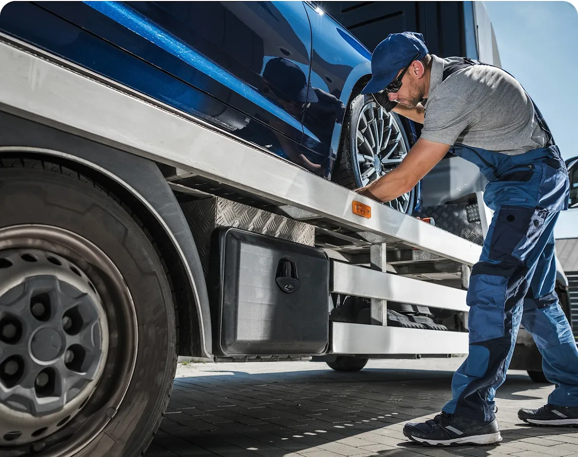 Mobile towing service provider performing emergency roadside service by Revilo Auto Care