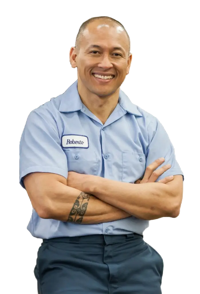 An image of an automotive technician with his arms crossed-representing on-demand car service by Revilo Auto Care
