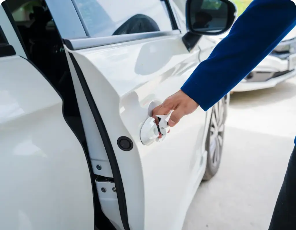 Become a Provider A man is opening the white car door after servicing at Revilo Auto Care service